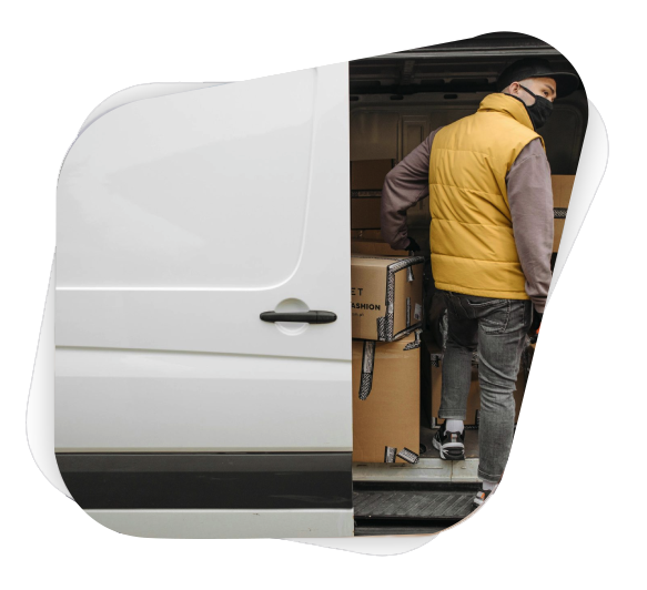 A deliveryman unloading packages from a van, showcasing modern logistics.