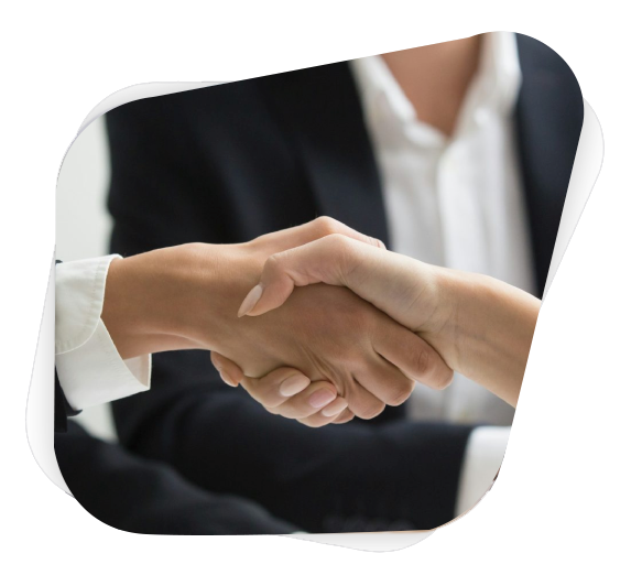 two people shaking hands in front of a laptop
